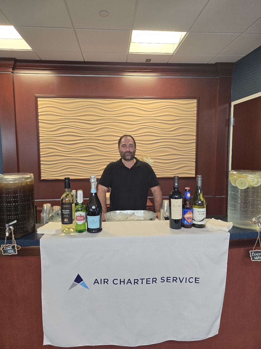 Bartender standing behind a clean mobile bar table