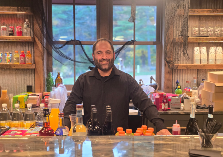 Bartender serving from a colorful event bar